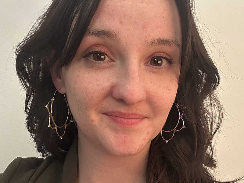 Portrait of a woman with long brown hair, brown eyes, and light skin in professional clothing