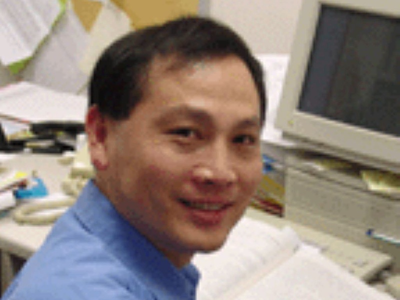 Man smiling at computer