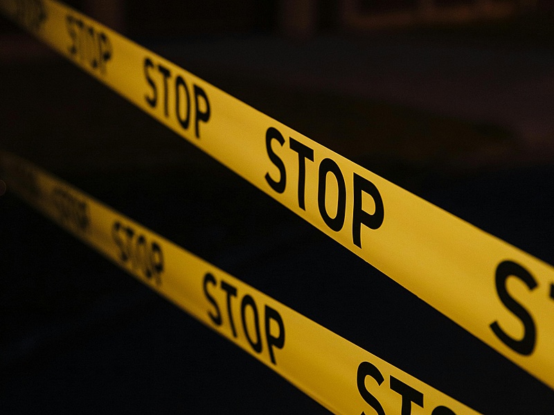 A yellow crime scene tape graphic with the word “STOP” stretched across it
