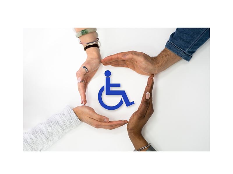 The image features four hands encircling a bright blue Symbol of Access (the international wheelchair symbol) on a white background.