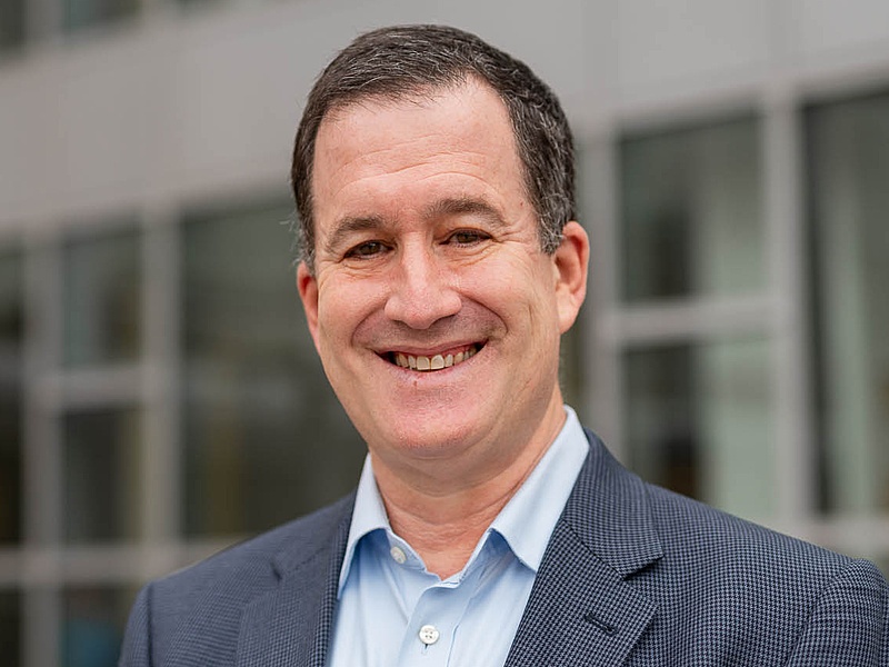 Portrait of David Hoffman in business attire on Main Street in The Commons