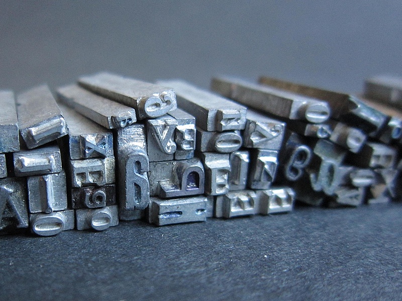 A pile of metallic letterpress forms
