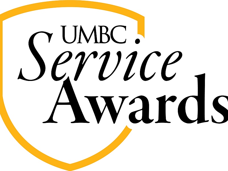Gold outline of the UMBC shield with the text "UMBC Service Awards" inside the outline.