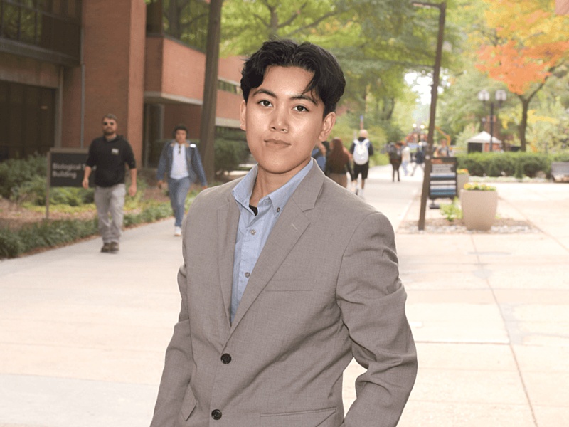 Thalia Anora standing with UMBC building in the background