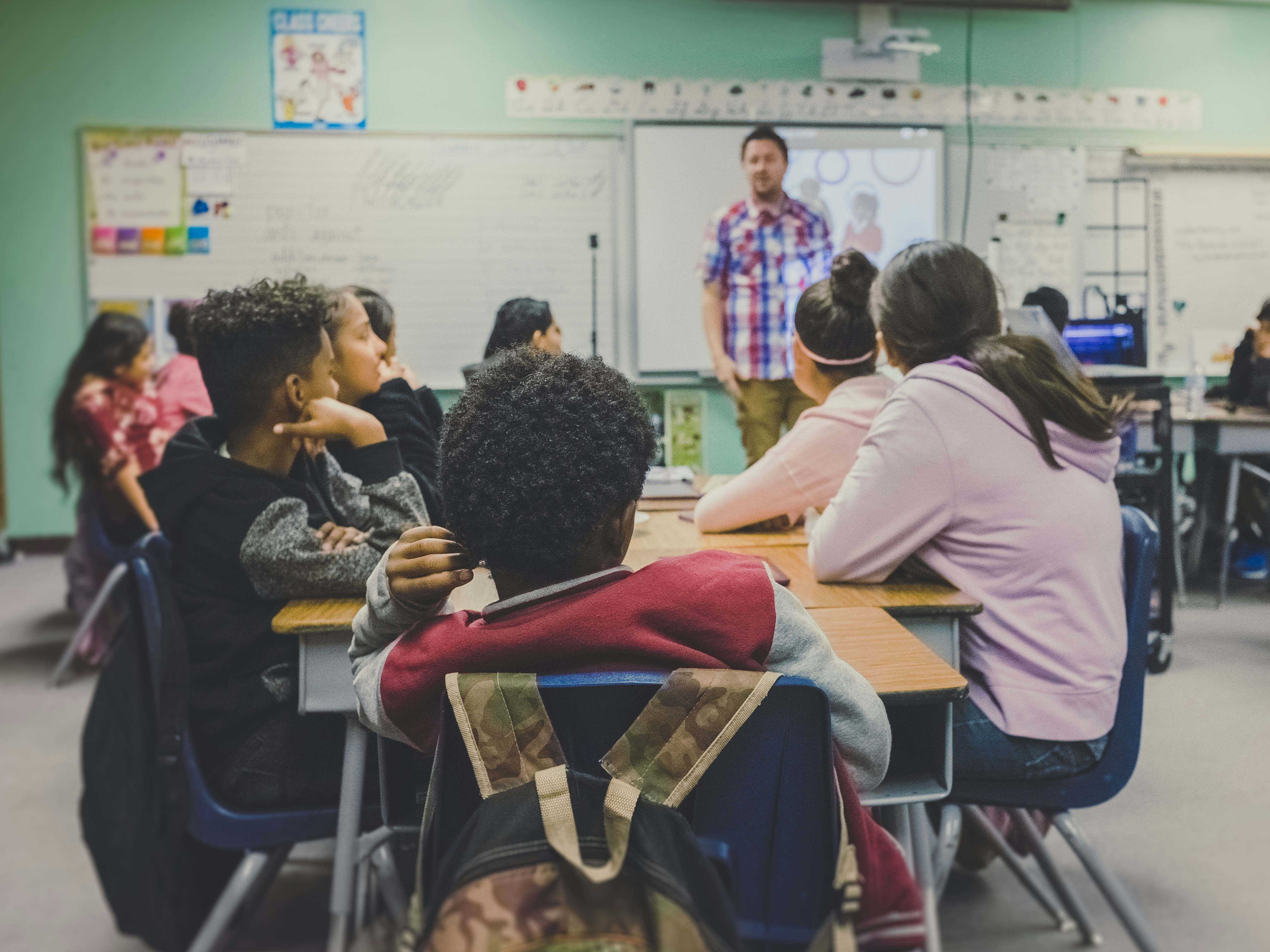 a classroom with middle schoolers and a teacher