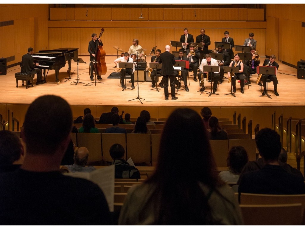 A group of musicians performs on stage.