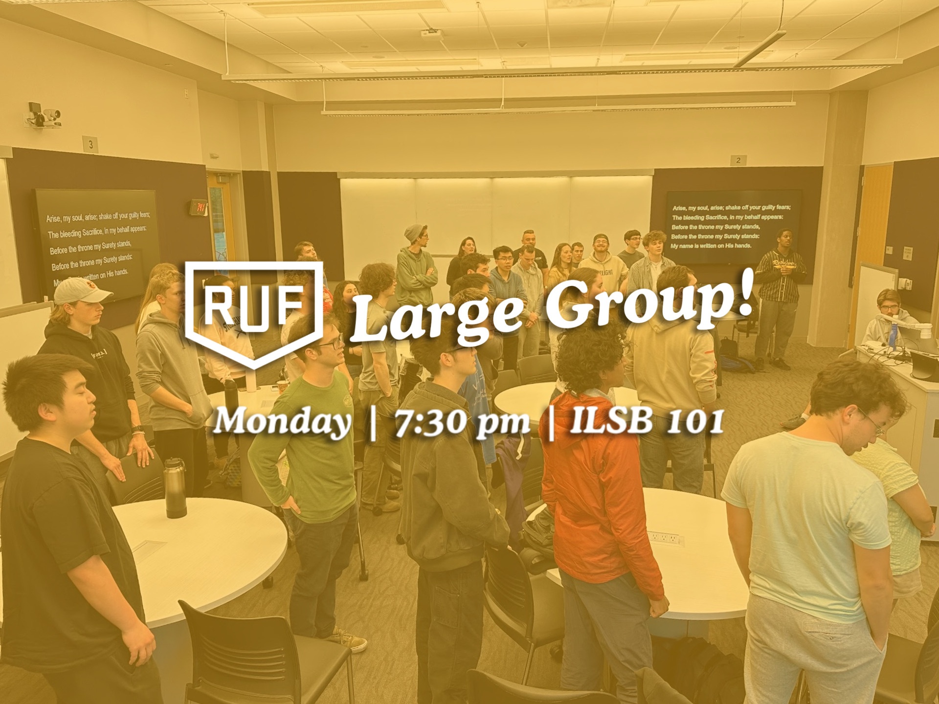 A group of students standing in a room singing together. The text reads: "RUF Large Group! Monday at 7:30 PM in ILSB 101."