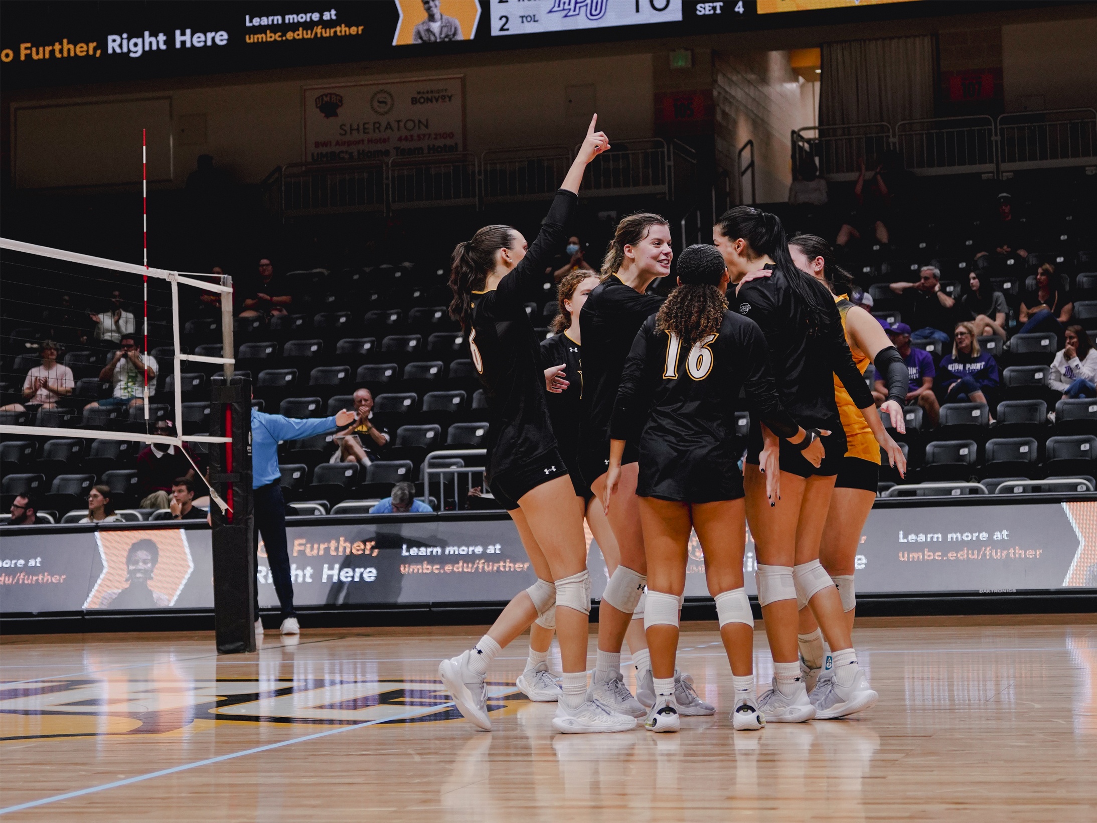 UMBC Volleyball players celebrating winning a point.