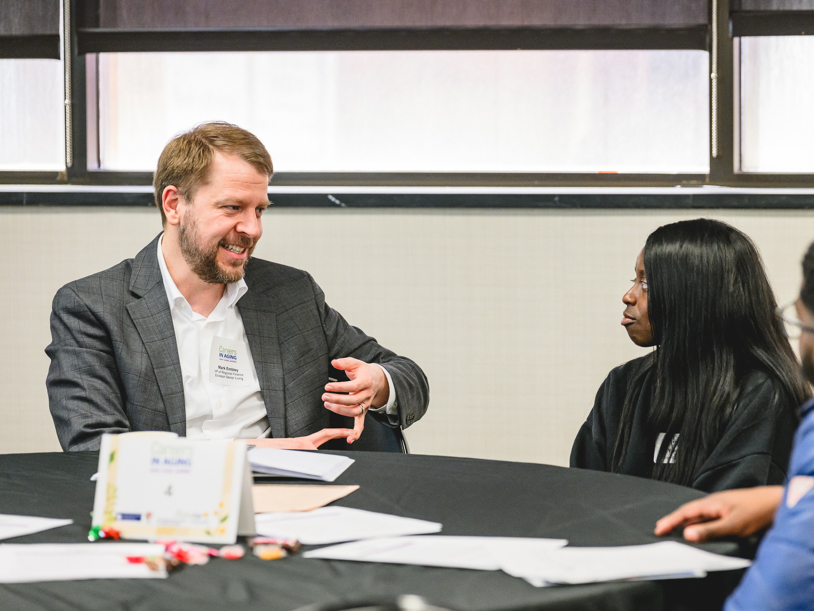 Aging Service Professional talking with student at Careers in Aging Event.