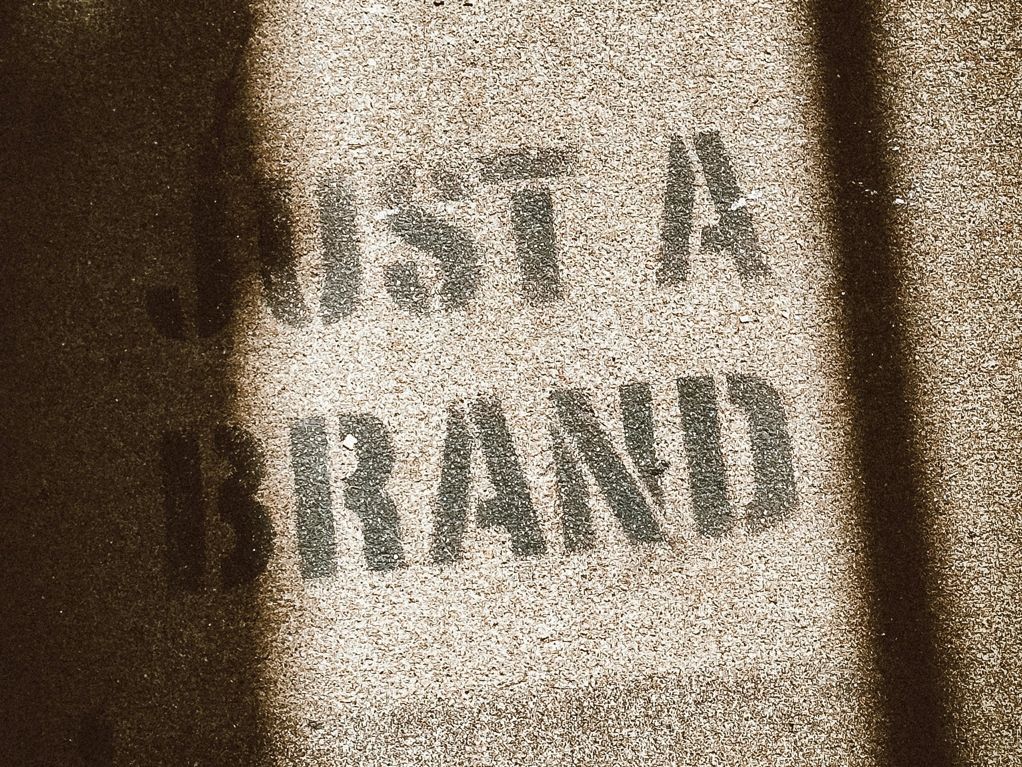The phrase "Just a brand" on a billboard