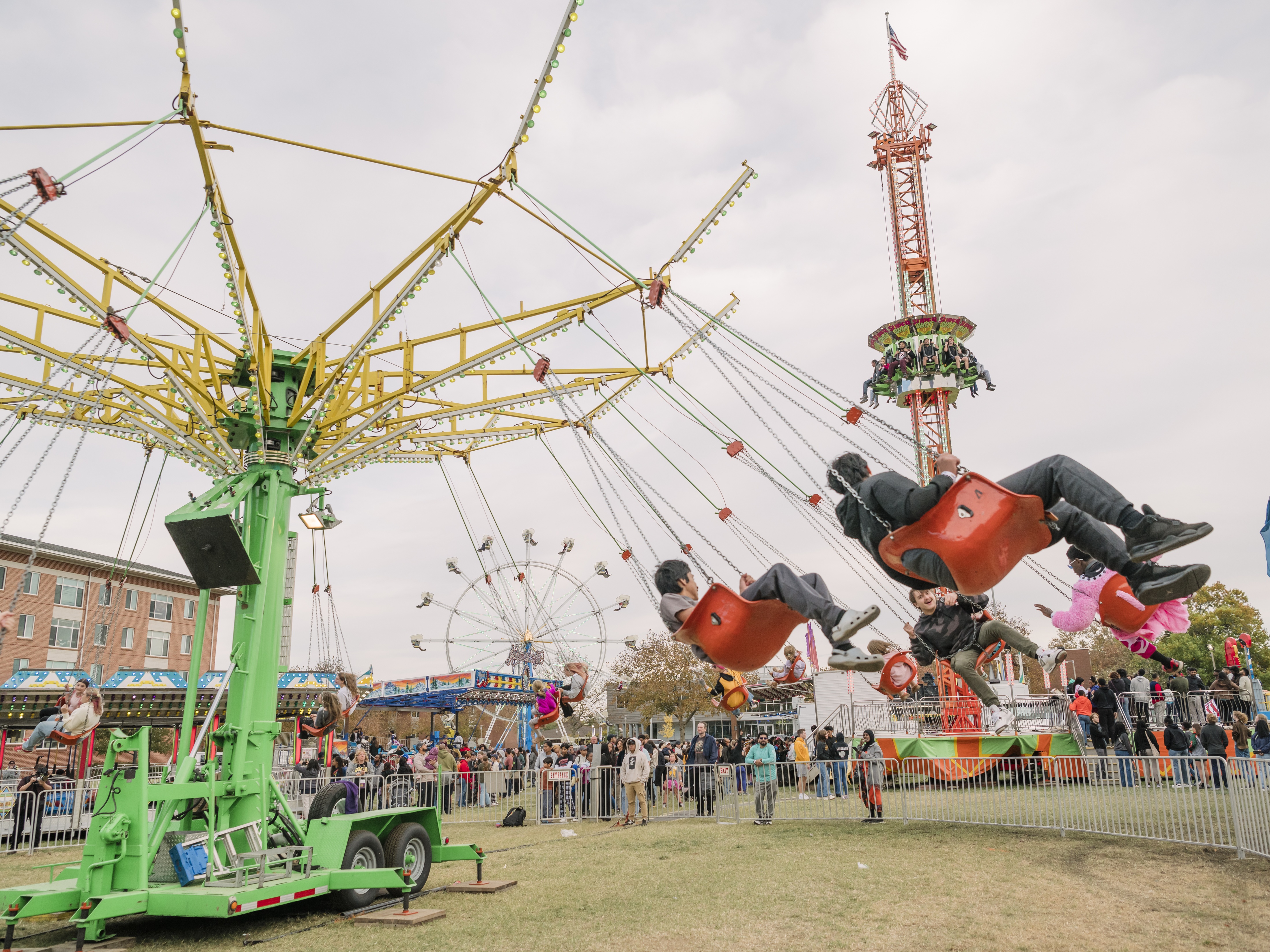 students riding a carnival ride at UMBC Homecoming